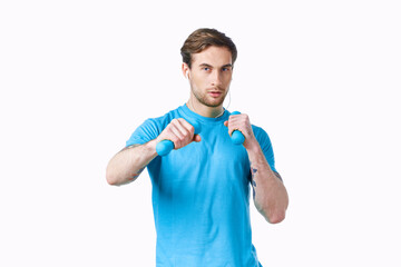 sports man with dumbbells in hands workout fitness light background