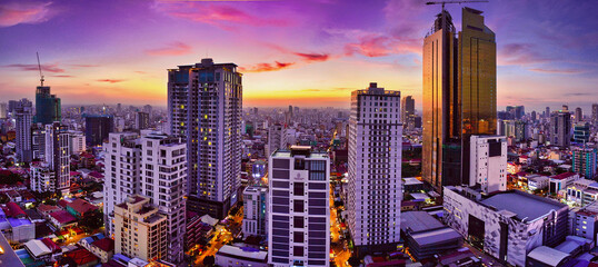Asian city center at sunset, areal view from a rooftop