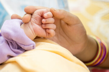 New Born baby hand hold by mother