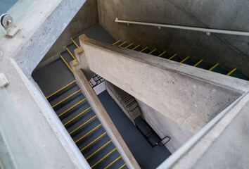 A staircase leads to stacked chairs in the basement