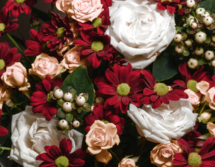 A beautiful bouquet of various flowers including roses. Floral background. Holiday postcard