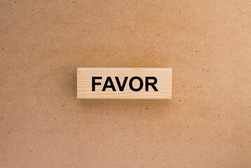 Wooden blocks with text Favor on the cardboard background