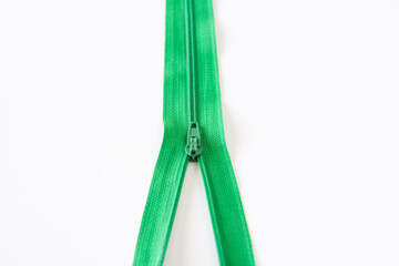 half open green zipper. Selective Focus. isolated White Background