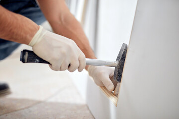 Young adult man working on a DIY budget renovation of his new home apartment.