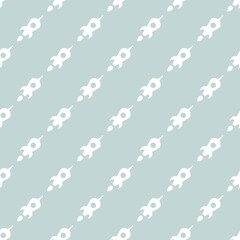 Seamless pattern with rocket ship silhouettes on turquoise background.