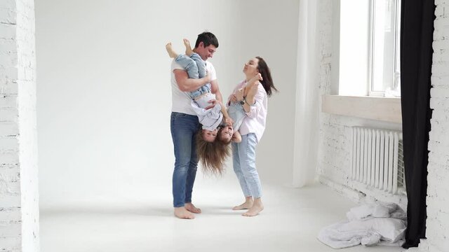 beautiful happy family at a photo shoot in a white photo studio. backstage.
