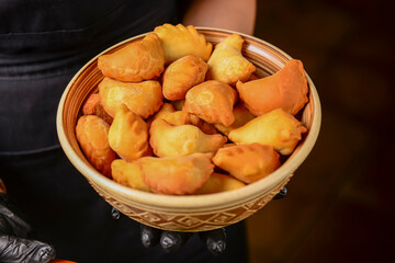 Pierogi Dumplings Varenyky. Heap of homemade varenyky dumplings with sour cream served by waiter