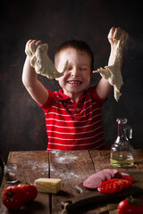 Child cooks from dough, plays, laughs