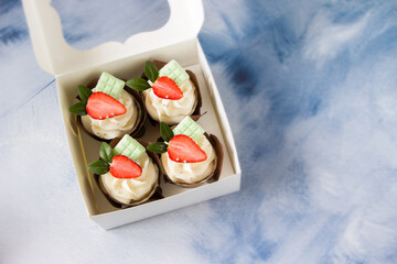 Strawberry cupcakes with cream cheese  in delivery box. Sweet food delivery