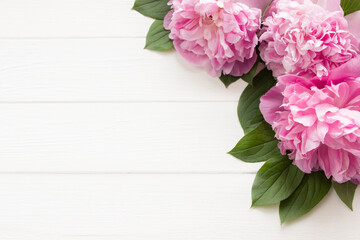 Pink peony flowers  on white wooden background with copy space. Mother's day, 8 march, women's day or wedding concept. Spring flowers background