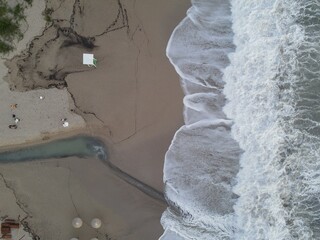 Aerial view wild sea waves in coast of karavostasi beach in perdika, epirus, greece
