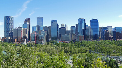Calgary city centre with tall skyscrapers aerial panoramic view, cityscape surrounded by river and green parks, Alberta, Canada