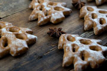 Christmas cookies in the shape of a Christmas tree. New Year's food. Anise star. Festive baked goods. Gingerbread on the table. Pattern