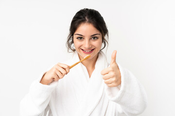 Young caucasian woman isolated on white background with a toothbrush