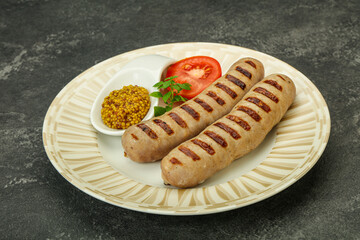 Grilled natural pork sausages with sauce