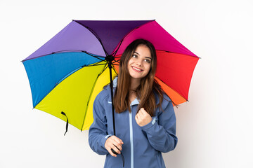 Woman holding an umbrella isolated on white background laughing and looking up