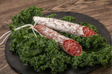 Spanish Fuet sausage with salad leaves