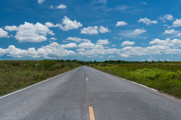 Small country road with blue sky background.