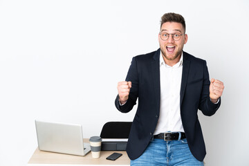 Russian man in a office isolated on white background celebrating a victory in winner position