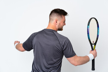 Russian handsome man isolated on white background playing tennis and celebrating a victory