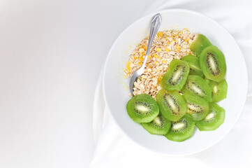 a plate of delicious oatmeal with green kiwi in the morning
