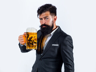 Elegant man drinking beer. Brewer holding glass with beer.