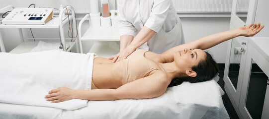 Obraz na płótnie Canvas Medical exam. Doctor doing preventive check-up of a female abdomen for examination of woman's internal organs