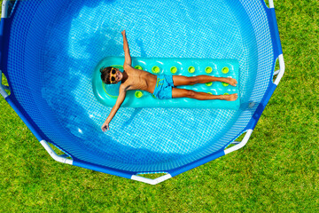 Boy swim on inflatable matrass view from above