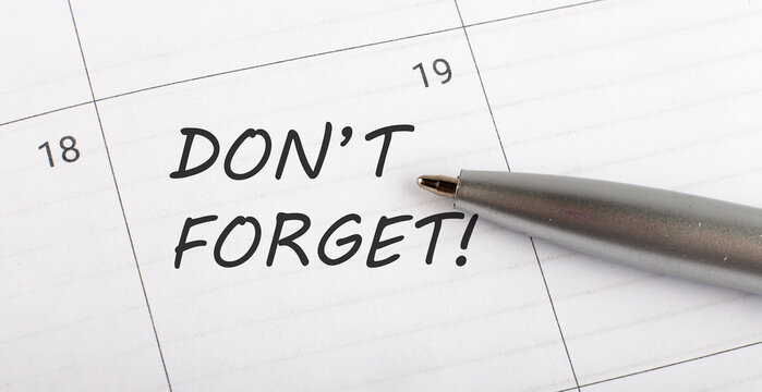 Text Don't Forget written on a calendar planner to remind you an important appointment with a pen on isolated white background.
