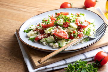 Traditional oriental salad Tabouleh. Tabule cous cous salad with vegetables. Tabbouleh with bulgur