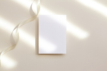 5x7 white photo frame mockup with ribbon on beige background