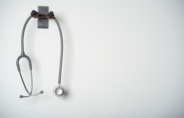 Fototapeta na wymiar stethoscope equipment of doctor with is hanging on the white wall background