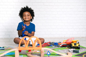 Happy black people African American child play toy at home 
