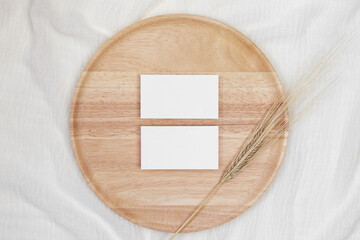 Two invitation name cards on wooden plate