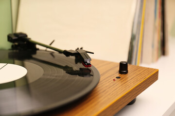 Fototapeta na wymiar Turntable with vinyl record on white table, closeup. Space for text
