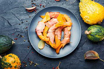 Baked pumpkin in bacon.