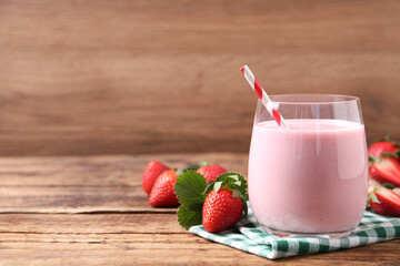 Delicious drink with strawberries on wooden table, space for text