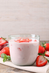 Delicious drink with strawberries on wooden table