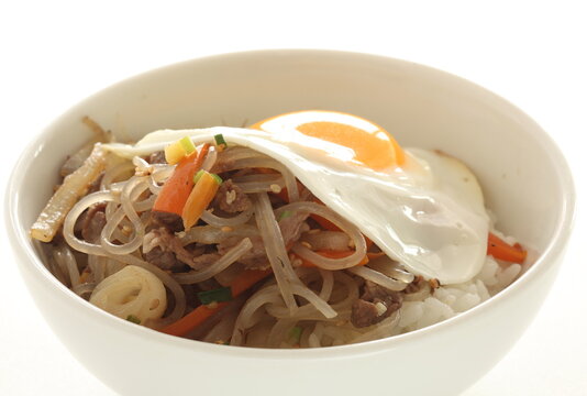 sunny side up fried egg on Korean Japchea green noodles stir fried