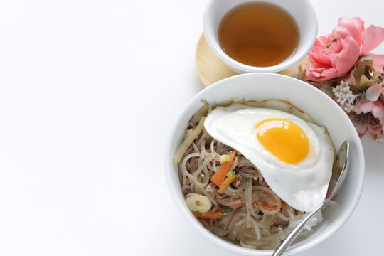 sunny side up fried egg on Korean Japchea green noodles stir fried