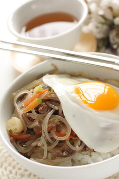 sunny side up fried egg on Korean Japchea green noodles stir fried