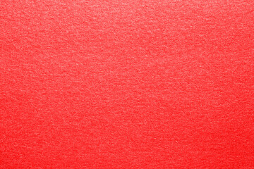 Closeup of a bright seamless red orange glitter sparkling metal paper texture for christmas gift design, Web, card with shiny surface and copy space for text. Macro.