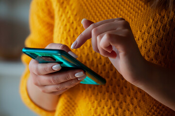 Woman using mobile phone, holding in hands