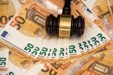 50 euro banknotes with wooden hammer as bribe concept