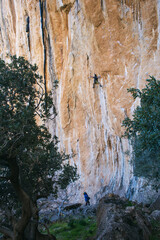 a girl insures a climber a man