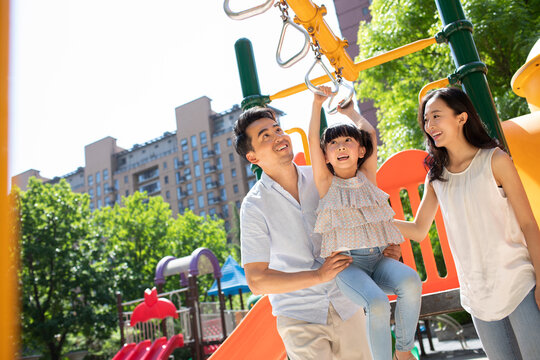 Happy young family playing in amusement park