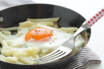 French fried and sunny side up fried up in  frying pan