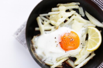 French fried and sunny side up fried up in  frying pan