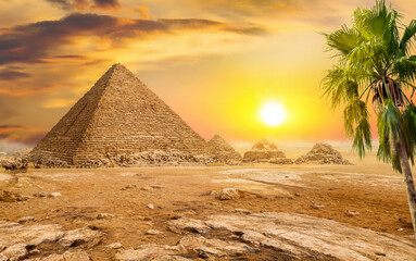 Fototapeta na wymiar Pyramids and sun