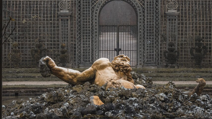 Beautiful scene of the Enceladus Fountain statue in Gardens of Versailles, France